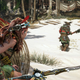A screenshot from Horizon Forbidden West depicting Aloy prowling on some unsuspecting guards.